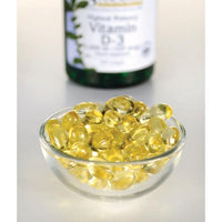 Thumbnail for Swanson Vitamin D3 - 5000 IU 250 softgel, essential for immune function and calcium absorption, can be seen in a bowl next to a bottle.