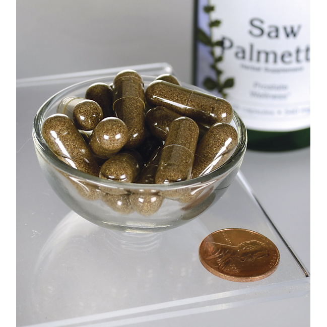 Swanson's Saw Palmetto - 540 mg 100 capsules, a popular prostate support supplement, are displayed in a bowl alongside a penny.