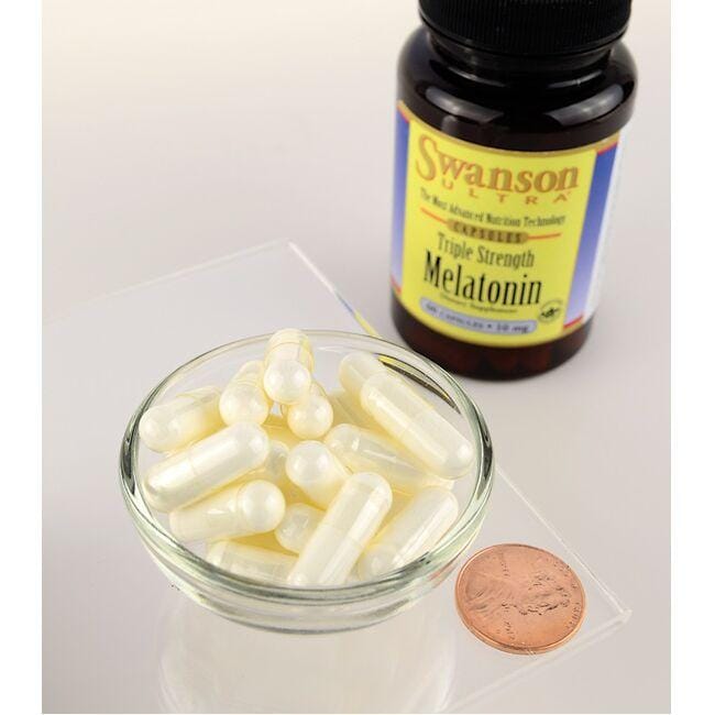 A bottle of Swanson Melatonin - 10 mg 60 capsules and a bowl of Swanson Melatonin - 10 mg 60 capsules.