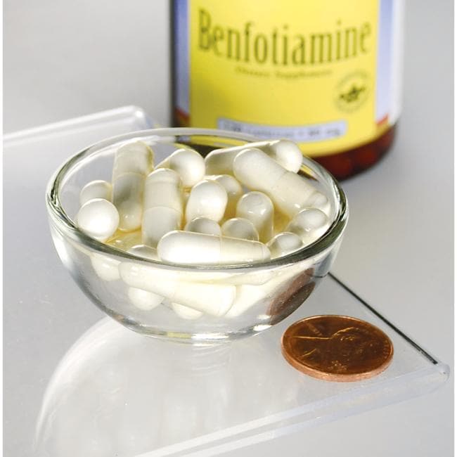 A bottle of Swanson Vitamin B-1 Benfotiamine - 80 mg 120 capsules next to a penny for maintaining healthy glucose metabolism.