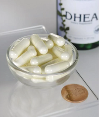 Thumbnail for A bottle of Swanson DHEA - High Potency - 25 mg 120 capsules in a bowl next to a penny.
