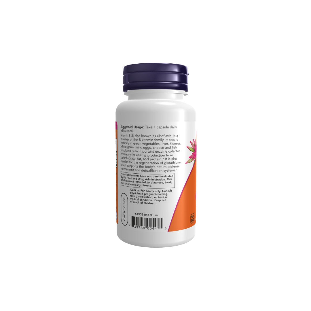A white Now Foods supplement bottle displaying the back label with dosage instructions, ingredients list, barcode, and a pink triangle design element including riboflavin (Vitamin B-2) for antioxidant effects.