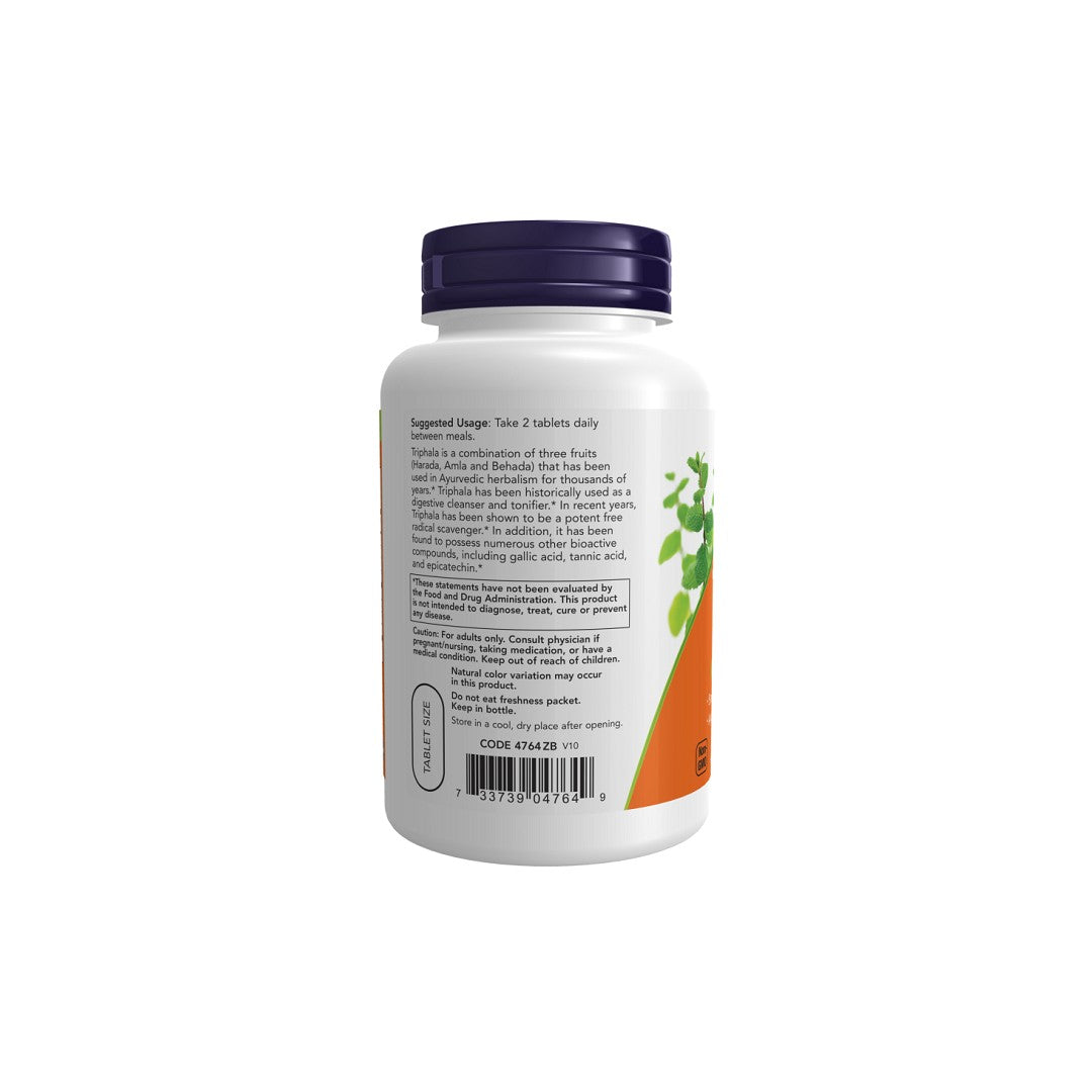 A white supplement bottle with a purple lid, displaying a label for Now Foods Triphala 500 mg 120 Tablets detoxification and digestion support, with dosage instructions and ingredients, isolated on a white background.