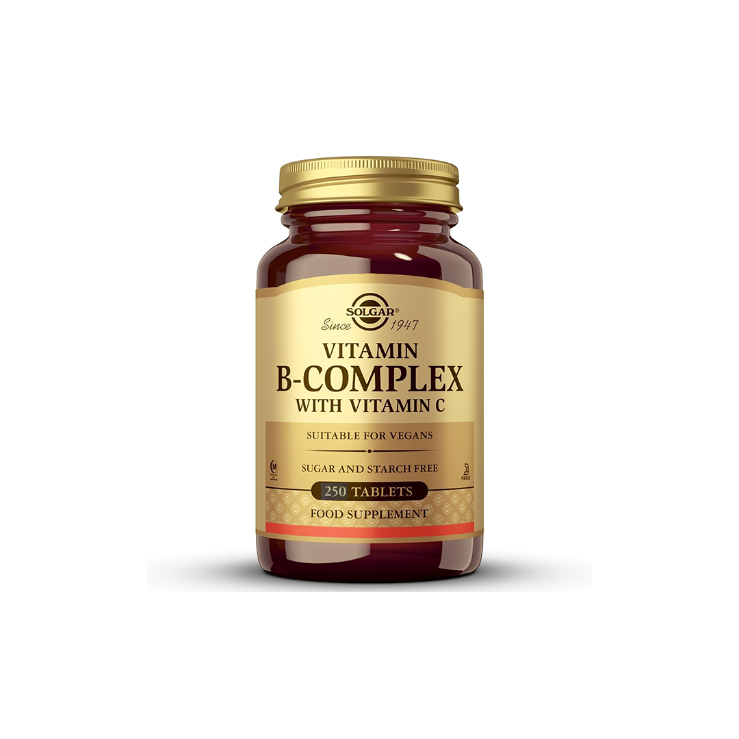 A brown bottle from Solgar labeled "Vitamin B-Complex with Vitamin C 250 Tablets" contains tablets that are suitable for vegans, free from sugar and starch, and support energy metabolism.