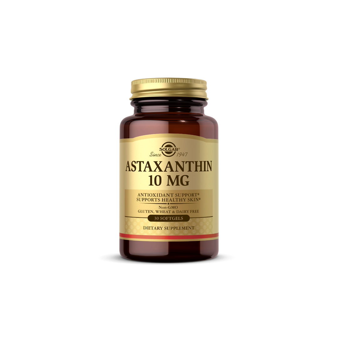 A bottle of Solgar's Astaxanthin 10 mg supplement, known for its potent antioxidant effects, is labeled as gluten-free and non-GMO, containing 30 softgels to aid in skin hydration.