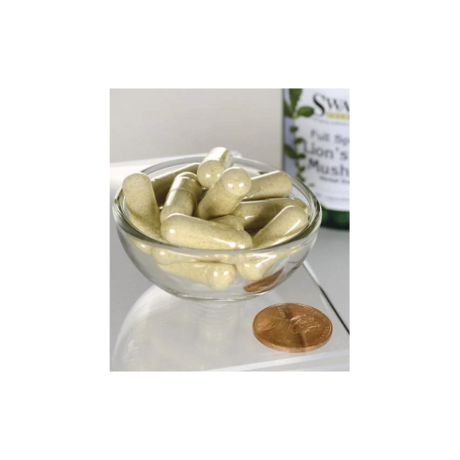 A glass bowl containing Swanson's Lion's Mane Mushroom 500 mg 60 Capsules, known for boosting cognitive function, rests beside a penny and a bottle.