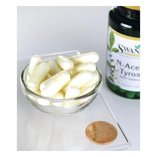 A small glass bowl filled with white capsules highlights the bioavailability of Swanson's N-Acetyl L-Tyrosine 350 mg. Beside it, a labeled bottle and a penny provide scale.