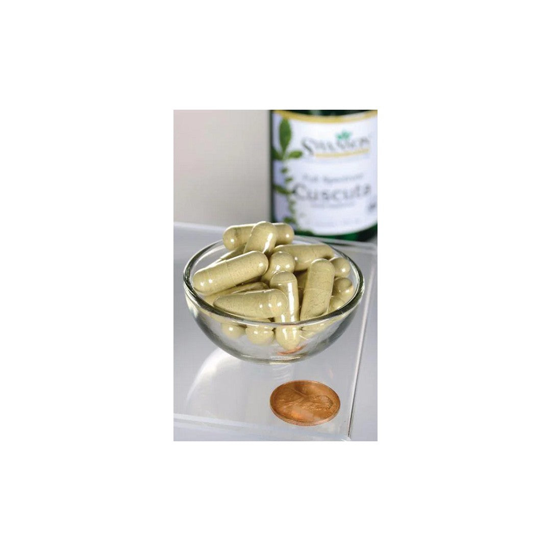 A bowl full of Swanson Cuscuta 400 mg 60 capsules and a bottle of oil.