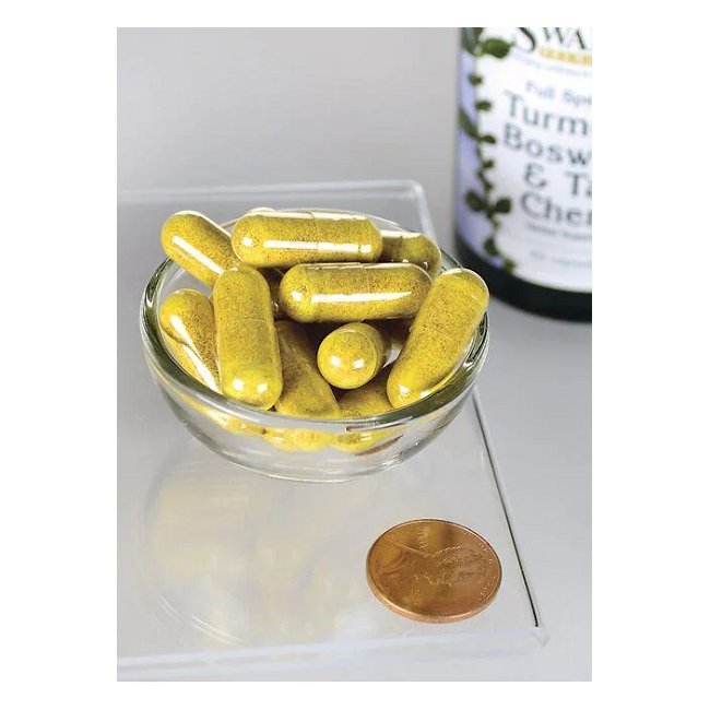 A small glass bowl contains yellow capsules next to a penny for scale, with a Swanson bottle labeled "Turmeric, Boswellia & Tart Cherry 60 Capsules" in the background, highlighting the blend's natural benefits.