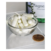 Thumbnail for A clear bowl with white capsules from Swanson's Magnesium Oxide 200 mg (250 Capsules) sits next to a penny and a labeled bottle, emphasizing its role in bone health on the transparent surface.