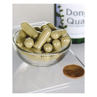 Thumbnail for A glass bowl filled with Swanson's Dong Quai 530 mg capsules sits beside a penny on a reflective surface, hinting at the benefits of traditional Chinese medicine, with a partially visible bottle in the background.