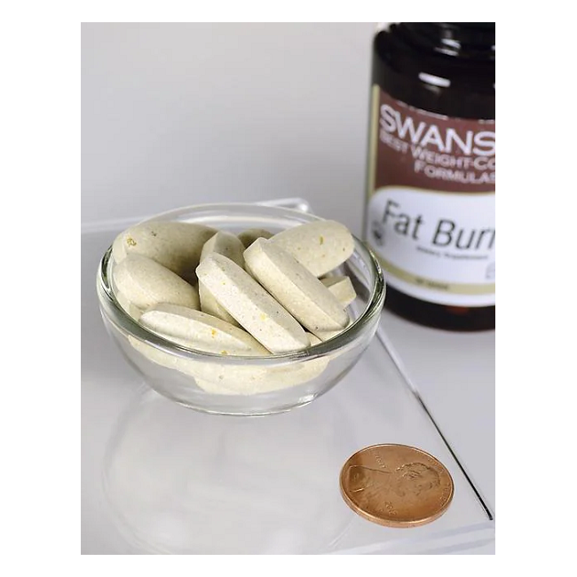 A small glass bowl with oval tablets is beside a "Swanson" bottle labeled "Fat burner 60 Tablets," featuring Garcinia cambogia, and a copper coin.