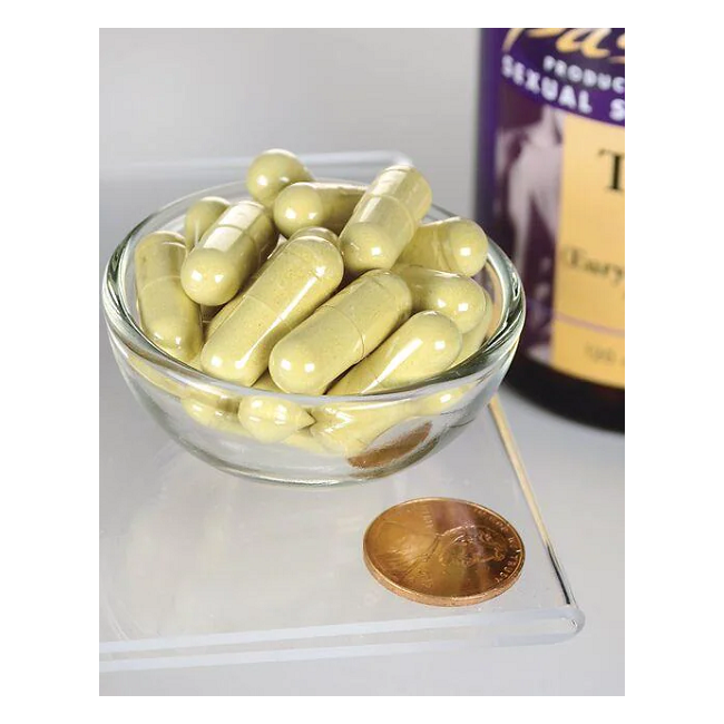 A small glass bowl filled with large, yellow capsules is placed beside a penny for scale. In the background, a Swanson bottle showcases its Tongkat Ali 400 mg 120 Capsules, famed for its natural aphrodisiac and invigorating qualities.