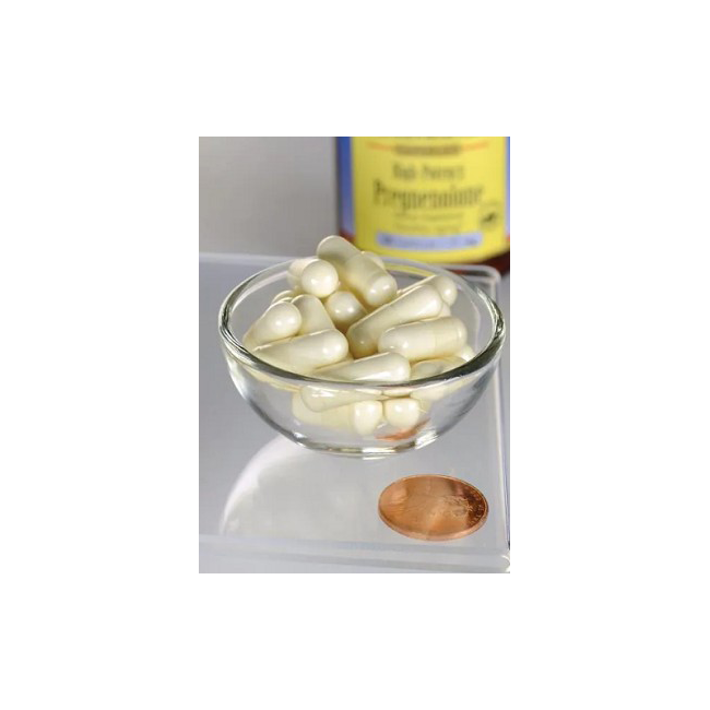 A glass bowl with white capsules rests beside a penny, indicating their small size. A blurred "Peppermint" label in the background suggests freshness. These are Swanson's Pregnenolone 25 mg capsules, implying a potential link to brain function.