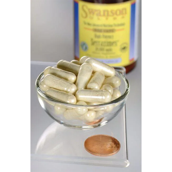A small glass bowl of white capsules next to a penny showcases Swanson High Potency Serrazimes 20,000 Units (60 Veggie Capsules) in the background—ideal for those seeking joint health support with proteolytic enzymes.