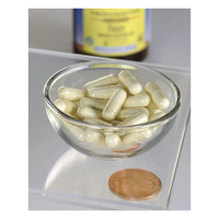 Thumbnail for A glass bowl containing white capsules, Swanson's Folate 5-MTHF - 400 mcg, ideal for pregnancy, rests on a clear surface beside a penny, with a blurred medicine bottle in the background.