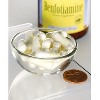 Thumbnail for A glass bowl filled with white capsules is displayed next to a penny for size comparison, illustrating the dimensions of this dietary supplement. In the background, a partially visible bottle labeled 