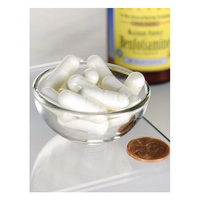 Thumbnail for A small glass bowl contains Swanson's Benfotiamine (Vitamin B1) 300 mg veggie capsules for energy, alongside a penny for scale, with a blurred bottle in the background.