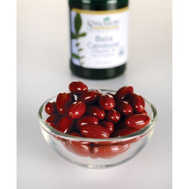 Red kidney beans in a bowl next to a dietary supplement bottle.