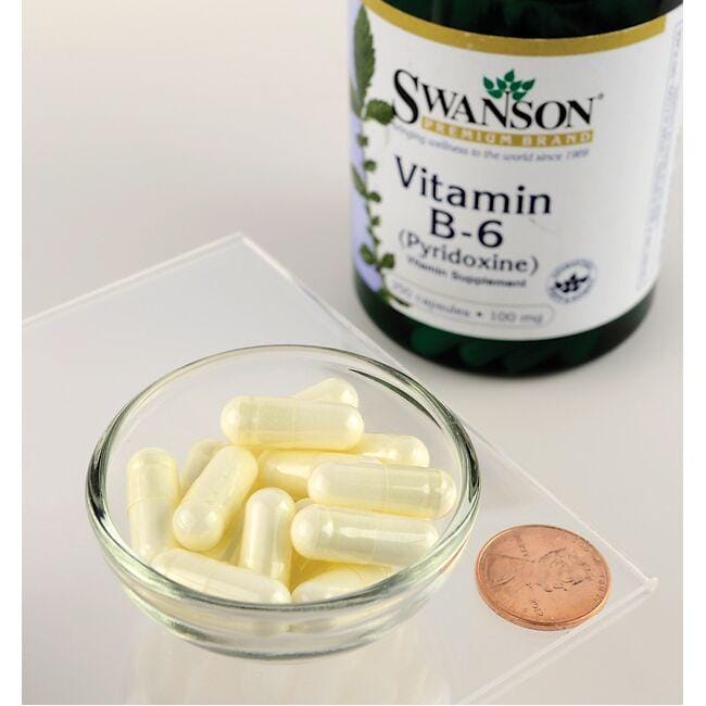 Swanson Vitamin B-6 Pyridoxine - 100 mg 250 capsules next to a bowl and a penny, promoting cardio health and enhancing energy metabolism.