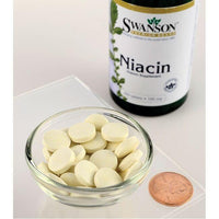 Thumbnail for A bottle of Swanson's Vitamin B-3 Niacin - 100 mg 250 tabs, a B-vitamin essential for heart health and carbohydrate metabolism, sits next to a bowl.