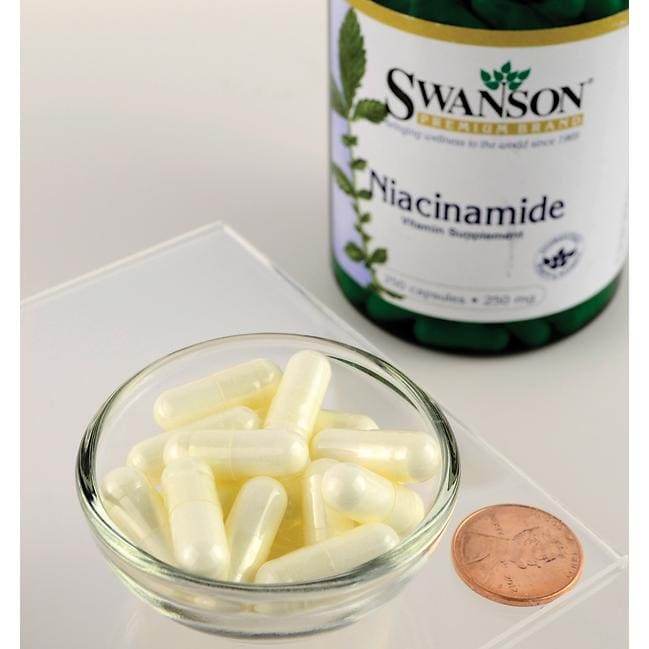 Swanson Vitamin B-3 Niacinamide capsules on a table next to a penny, promoting Swanson Vitamin B-3 Niacinamide for its benefits in carbohydrate metabolism.