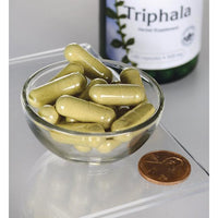 Thumbnail for Swanson Triphala with Amla, Behada & Harada - 500 mg 100 capsules, a dietary supplement for maintaining a healthy digestive system, are displayed in a bowl alongside a bottle.