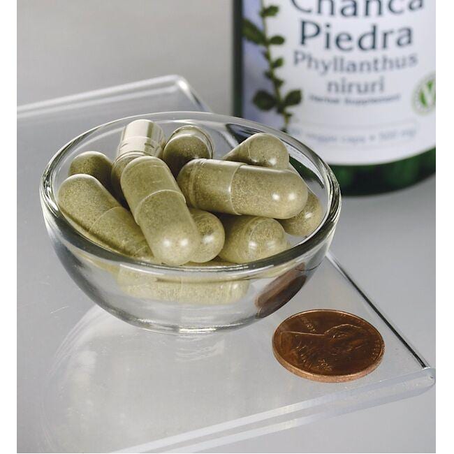 A bottle of Swanson's Chanca Piedra - 500 mg 60 vege capsules in a glass bowl.