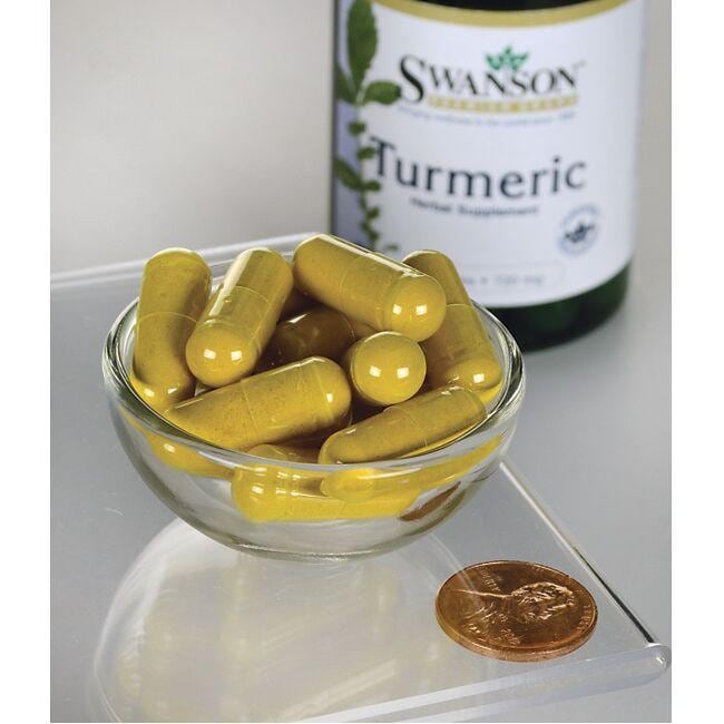 A bowl of Swanson turmeric capsules - 720 mg 30 capsules, providing antioxidant support and promoting joint health, on a table next to a penny.