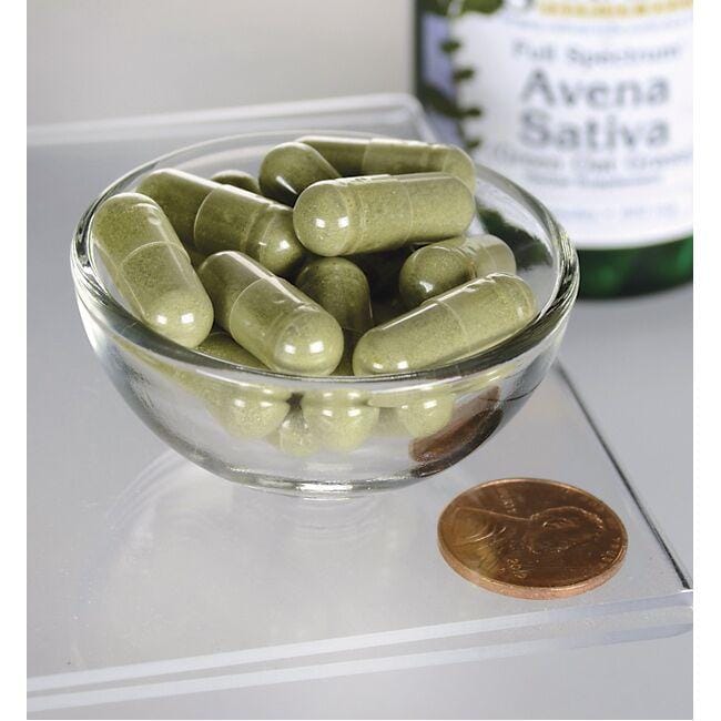 A bowl of Swanson Avena Sativa - 400 mg 60 capsules next to a bottle of olive oil.