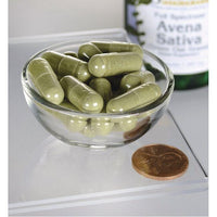 Thumbnail for A bowl of Swanson Avena Sativa - 400 mg 60 capsules next to a bottle of olive oil.