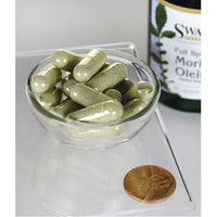 Thumbnail for Swanson's Moringa Oleifera - 400 mg 60 capsules in a bowl next to a bottle of Swanson's Moringa Oleifera, highlighting the benefits of reducing oxidative stress and cell damage.