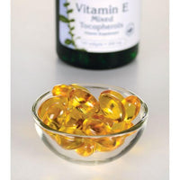 Thumbnail for Swanson Vitamin E - 400 IU 100 softgel Mixed Tocopherols, an antioxidant support and essential nutrient for cardiovascular health, displayed in a bowl alongside a bottle, is designed to combat free radical damage.