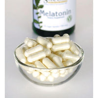 Thumbnail for Swanson Melatonin - 0,5 mg 60 vege capsules in a glass bowl next to a bottle.