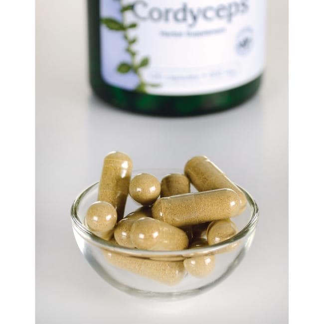 Swanson Cordyceps - 600 mg 120 capsules in a bowl next to a bottle of Swanson Cordyceps.