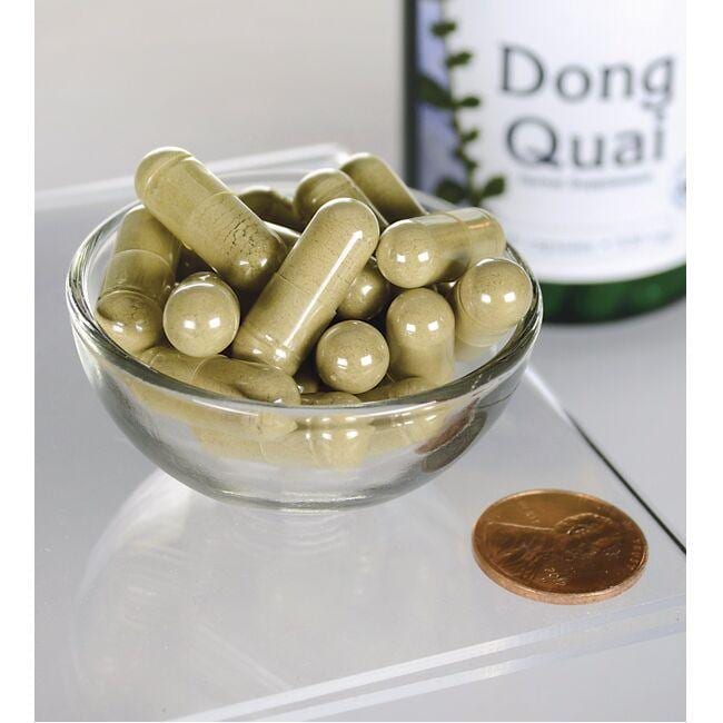 Swanson Dong Quai - 530 mg 100 capsules in a bowl next to a bottle.