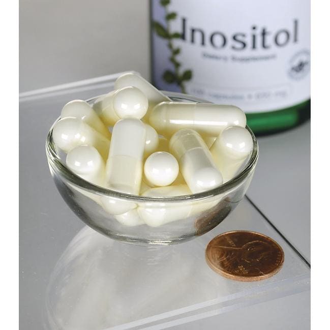 Swanson Inositol - 650 mg 100 capsules in a bowl next to a bottle of Swanson Inositol.