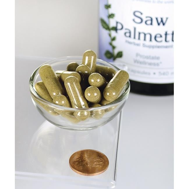 Swanson Saw Palmetto - 540 mg 250 capsules, known for their role in promoting prostate health and urinary tract flow, are displayed in a bowl alongside a penny.