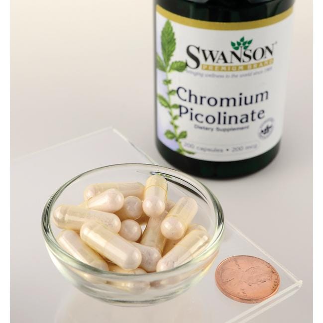 A bowl of Swanson Chromium Picolinate - 200 mcg 200 capsules next to a penny.