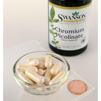 Thumbnail for A bowl of Swanson Chromium Picolinate - 200 mcg 200 capsules next to a penny.