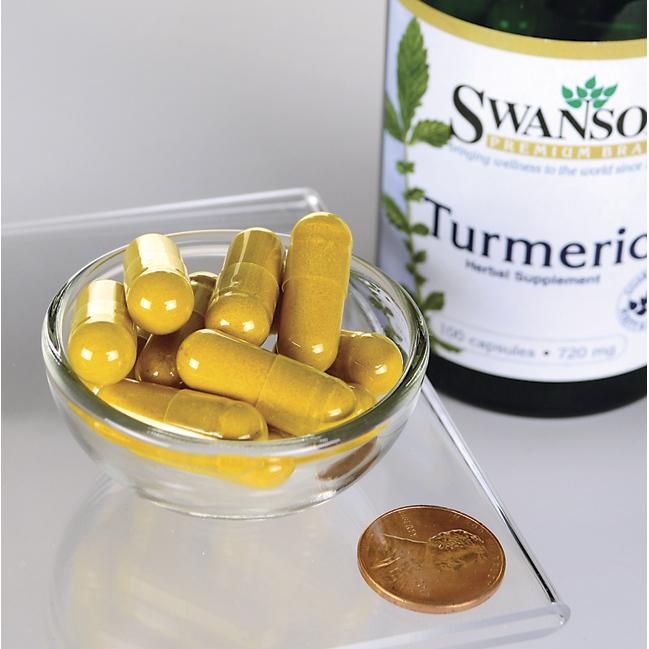 A bottle of antioxidant-rich Swanson's Turmeric - 720 mg 100 capsules placed next to a penny for size reference.