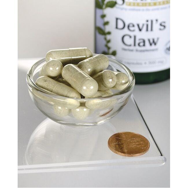 Swanson's Devil's Claw - 500 mg 100 capsules in a bowl with a coin.