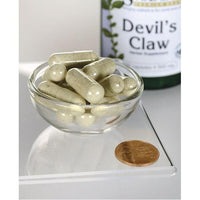 Thumbnail for Swanson's Devil's Claw - 500 mg 100 capsules in a bowl with a coin.
