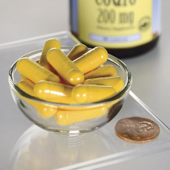 Swanson Coenzyme Q10 - 200 mg 90 capsules in a bowl next to a penny.