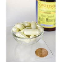Thumbnail for A bowl containing a bottle of Swanson's Multi Mineral With Iron - 120 capsules Albion Chelated vitamins and minerals. Additionally, there is a penny placed next to the bottle.