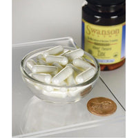 Thumbnail for Swanson's Zinc - 30 mg 90 capsules Albion Chelated, known for its positive impact on prostate health and immune function, is elegantly presented in a glass bowl alongside a penny. This captivating scene visually embodies the potential benefits these capsules offer for.
