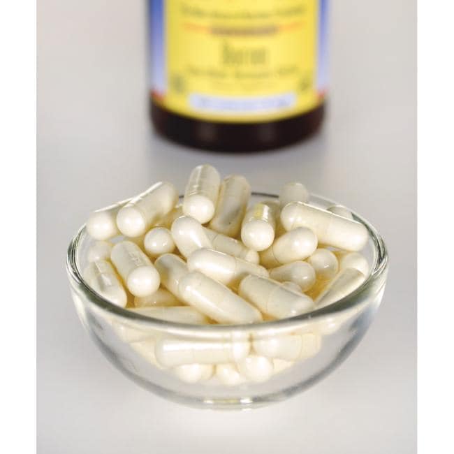 Swanson Albion Boron Bororganic Glycine - 6 mg 60 capsules in a bowl next to a bottle of vitamin c.
