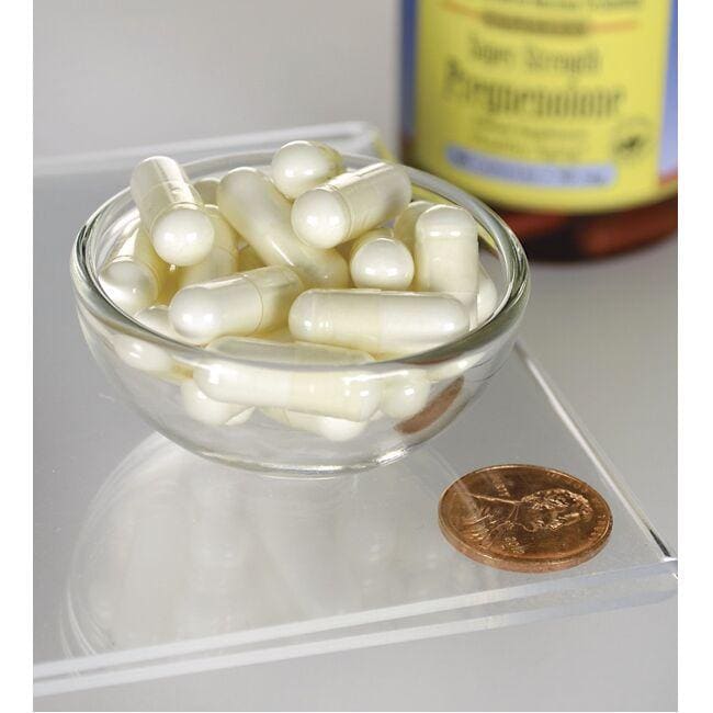 A bowl of Swanson pregnenolone - 50 mg 60 capsules next to a penny, promoting brain function with the prohormone pregnenolone.