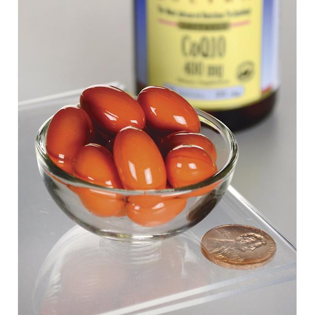 A glass bowl filled with tomatoes and a Swanson Coenzyme Q1O - 400 mg 30 softgels.