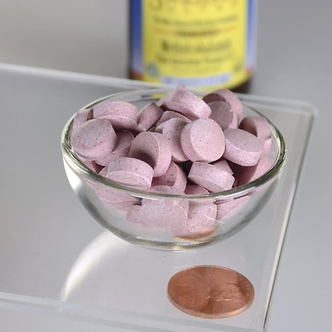 Swanson Vitamin B-12 - 2500 mcg 60 tabs Methylcobalamin pills in a glass bowl next to a penny, promoting metabolic health and red blood cell production.